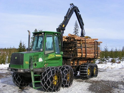Форвардер JOHN DEERE 1110d осуществляет погрузку бревен